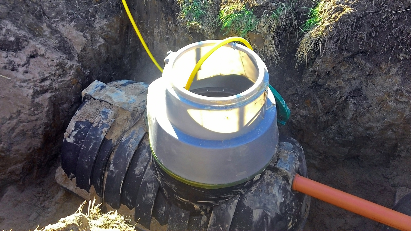 Plumbing drain pipe is being connected to septic tank